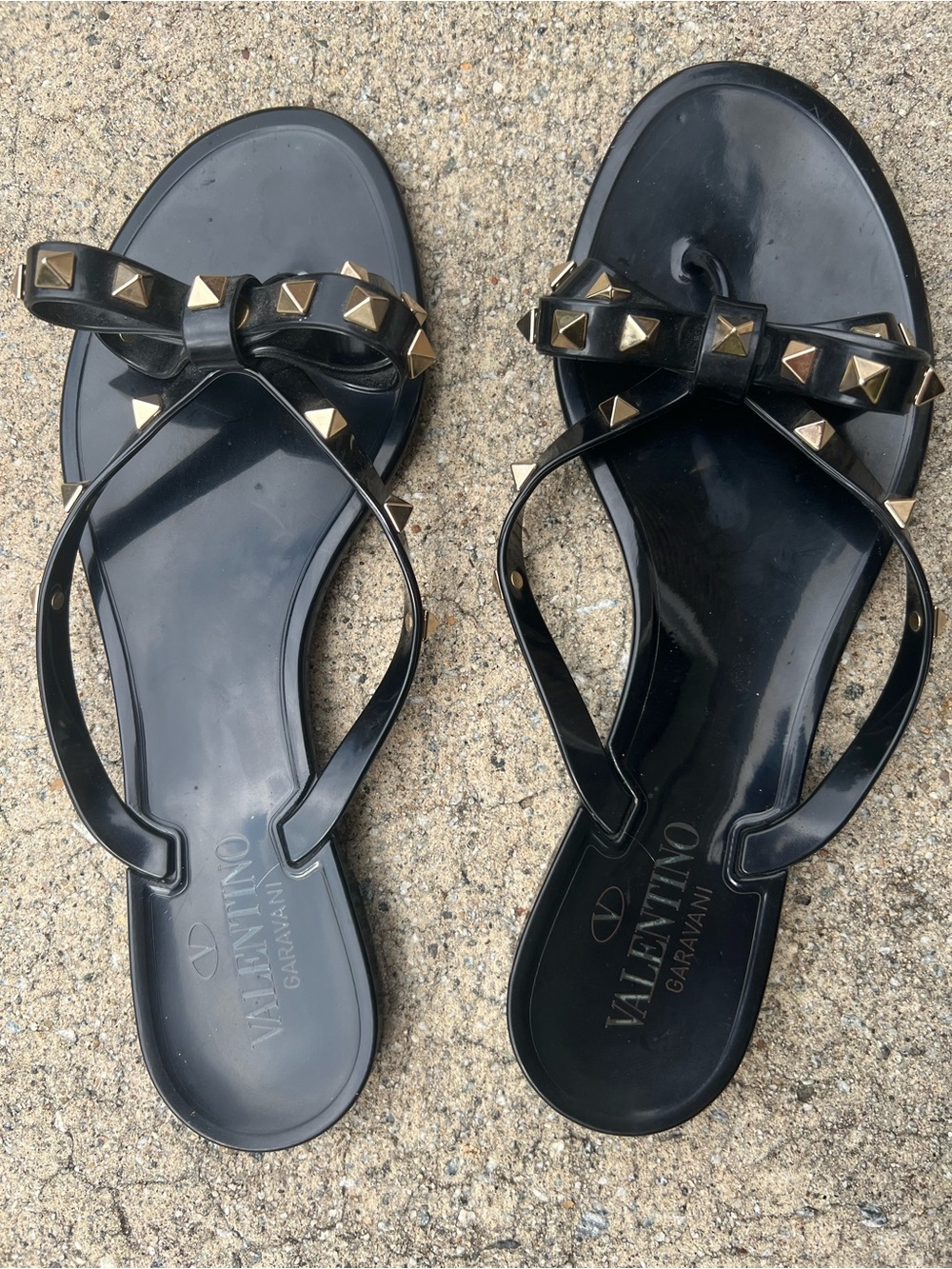 Valentino Garavani Black Jelly Sandals with Gold Rockstud Bow